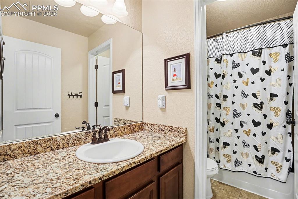 Image 19 of 31: Additional bathroom upstairs with granite counters
