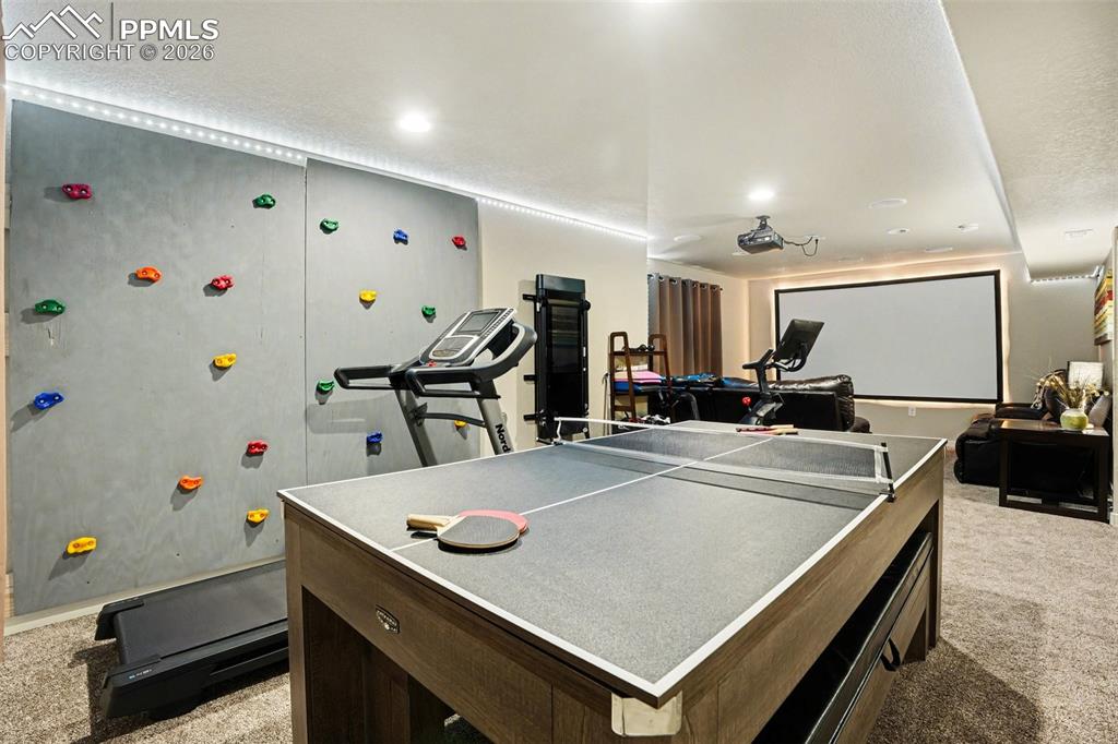 Image 21 of 31: Fantastic family room in basement with climbing wall!