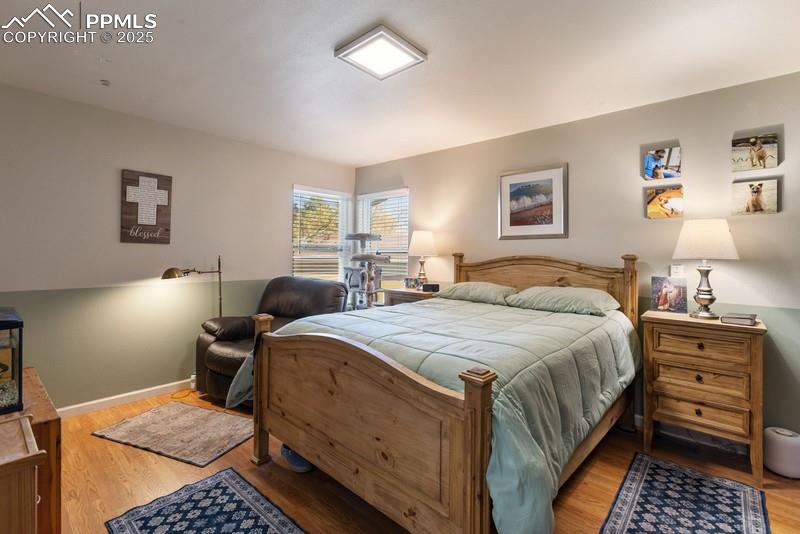 Image 24 of 29: Bedroom with light wood-type flooring and baseboards
