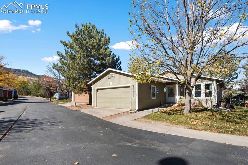 Image 4 of 29: Ranch-style house featuring driveway and a garage