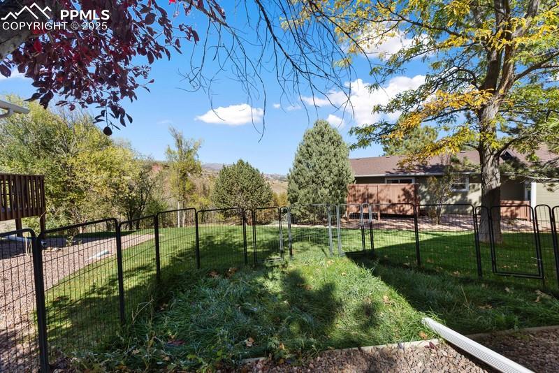 Image 5 of 29: View of fenced backyard
