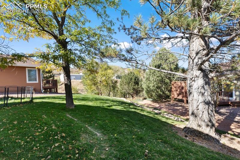 Image 6 of 29: View of yard with a wooden deck