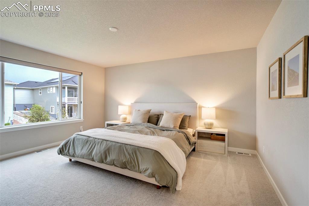 Image 16 of 47: Carpeted bedroom featuring baseboards and a textured ceiling