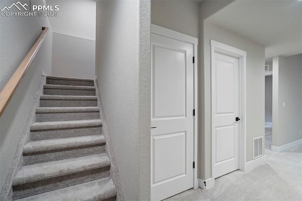 Image 32 of 47: Stairs featuring carpet flooring and baseboards