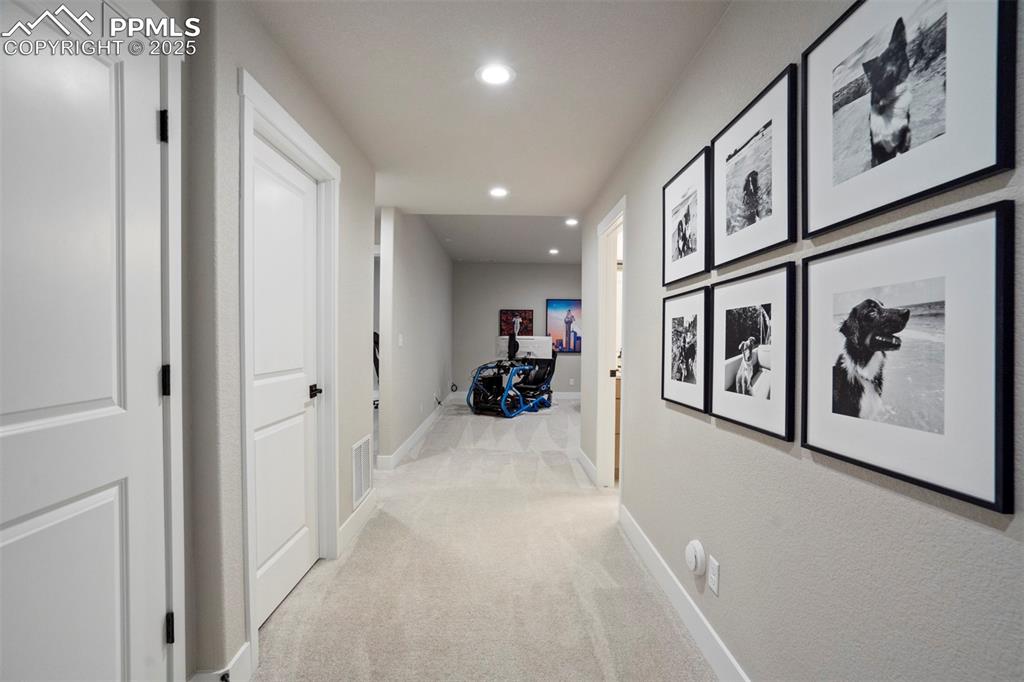 Image 33 of 47: Hallway with baseboards, recessed lighting, and carpet