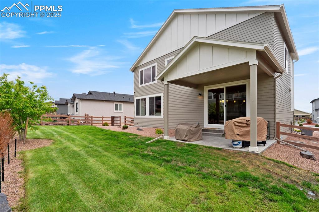 Image 35 of 47: Rear view of property featuring board and batten siding and a patio area