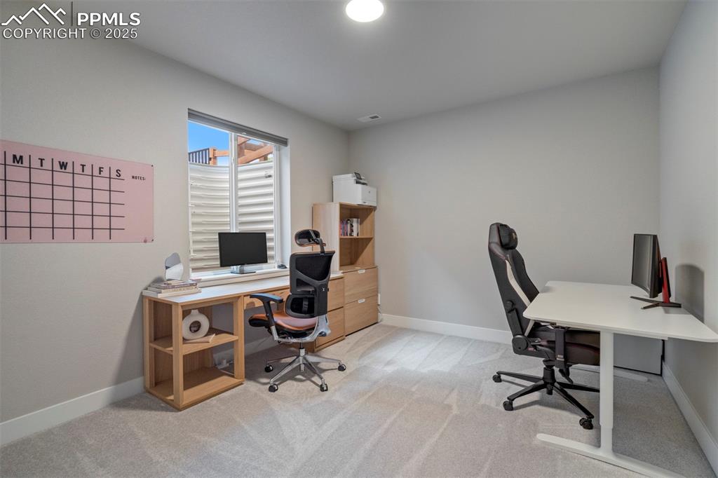 Image 38 of 47: Office space with light carpet and baseboards