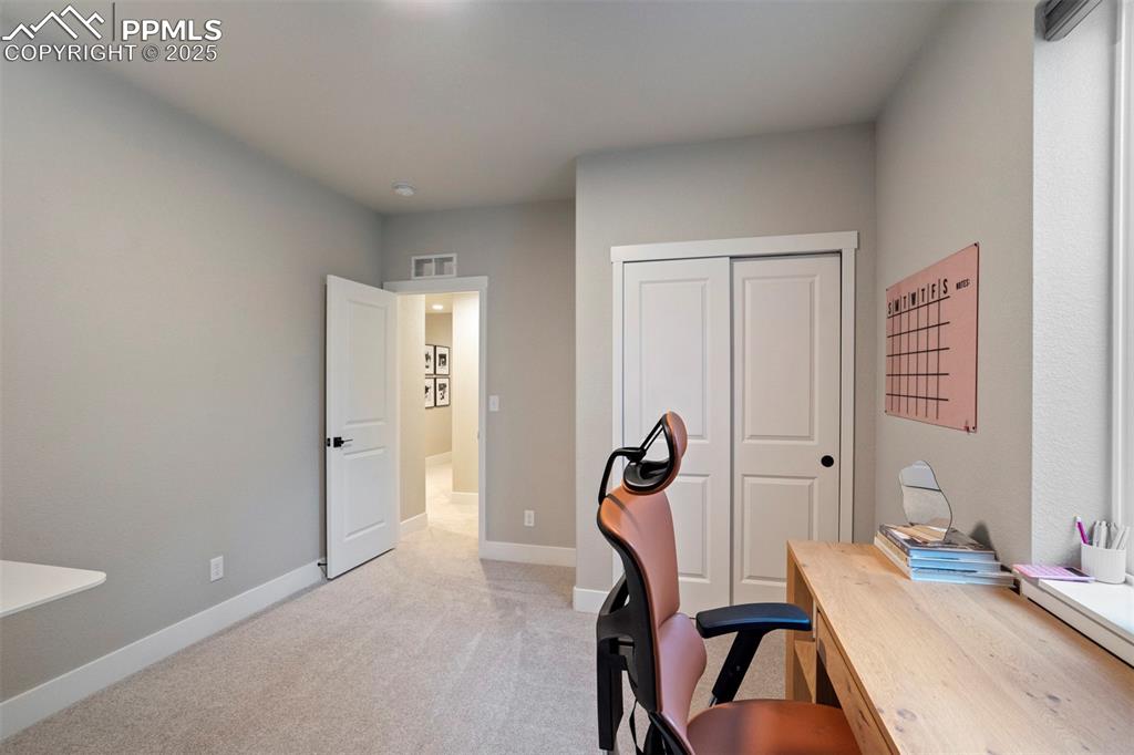 Image 39 of 47: Office with light carpet and baseboards