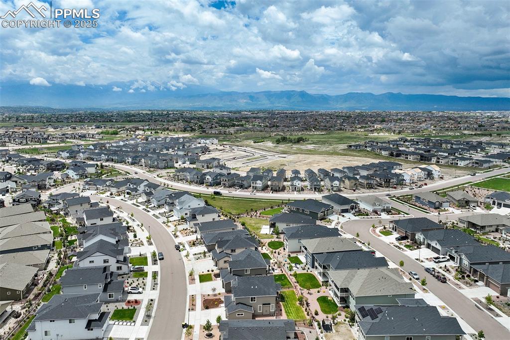 Image 45 of 47: Aerial view of residential area with a mountain backdrop