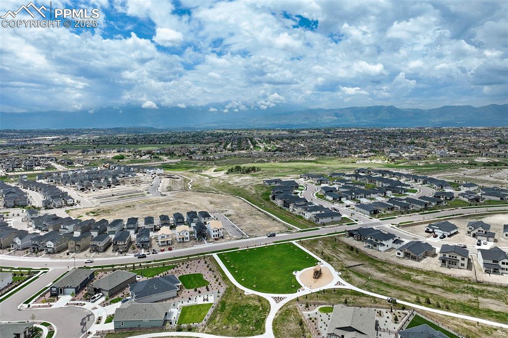 Image 46 of 47: Aerial view of residential area with a mountain backdrop