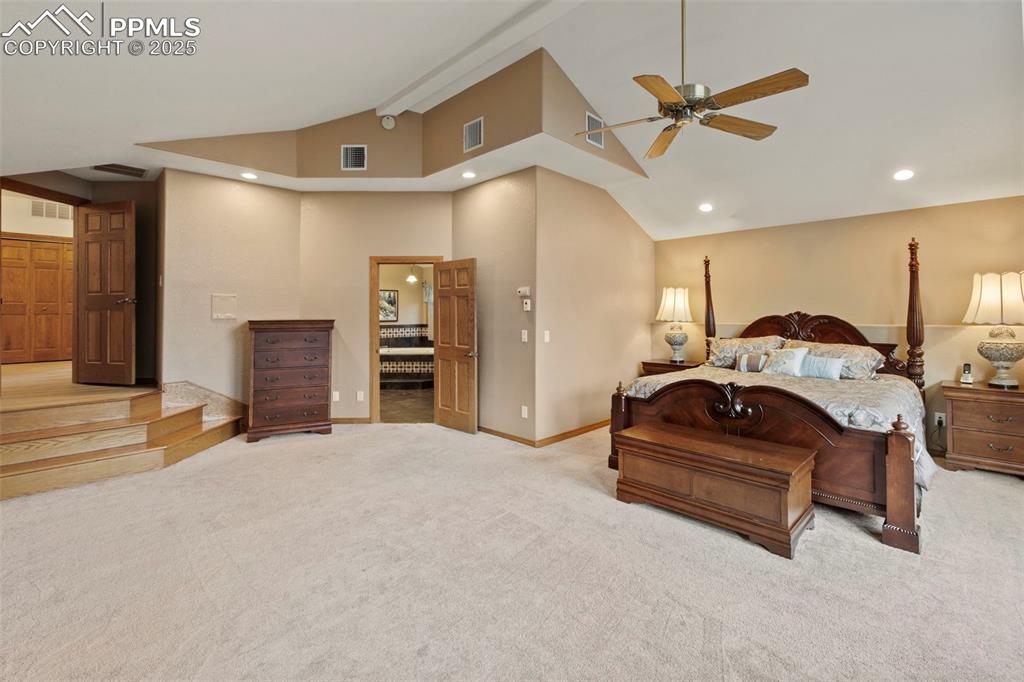 Image 25 of 50: Bedroom featuring recessed lighting, light carpet, a ceiling fan, and high 