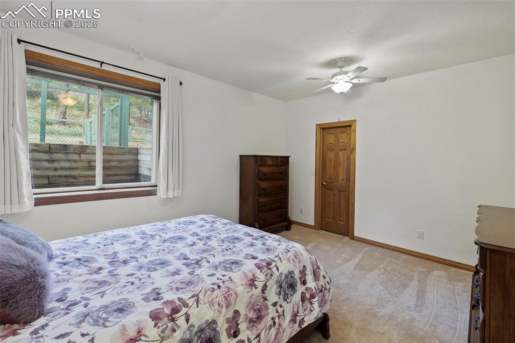 Image 33 of 50: Bedroom featuring light carpet and a ceiling fan
