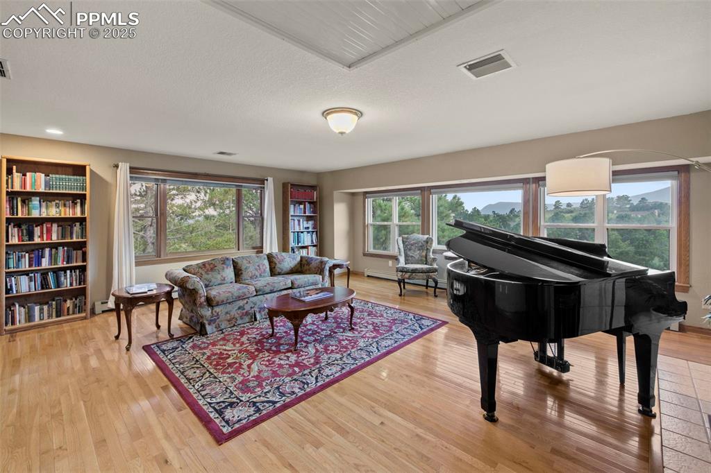 Image 4 of 50: Living area with light wood-type flooring