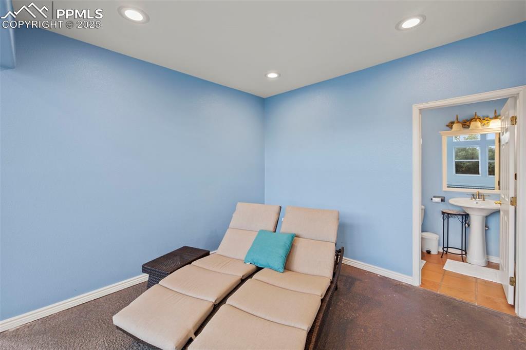 Image 42 of 50: Living area with recessed lighting, tile patterned floors, and carpet floor