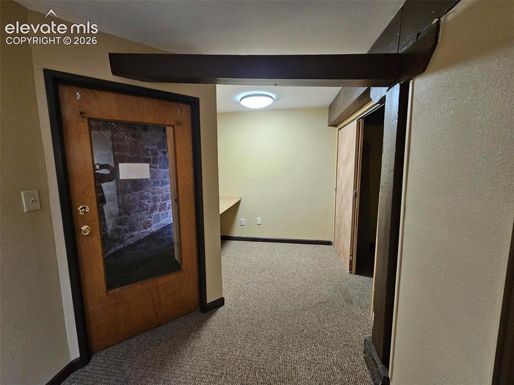Image 4 of 11: Entry to unit - workroom and storage to the left of entry door.