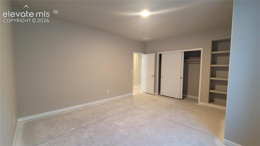 Image 22 of 29: 3rd Bedroom with built-in shelving, located in the lower-level! Please, exc