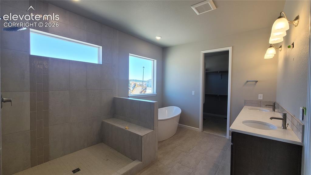Image 9 of 29: Primary Suite is accompanied with a plush 5-piece bathroom, and two walk-in