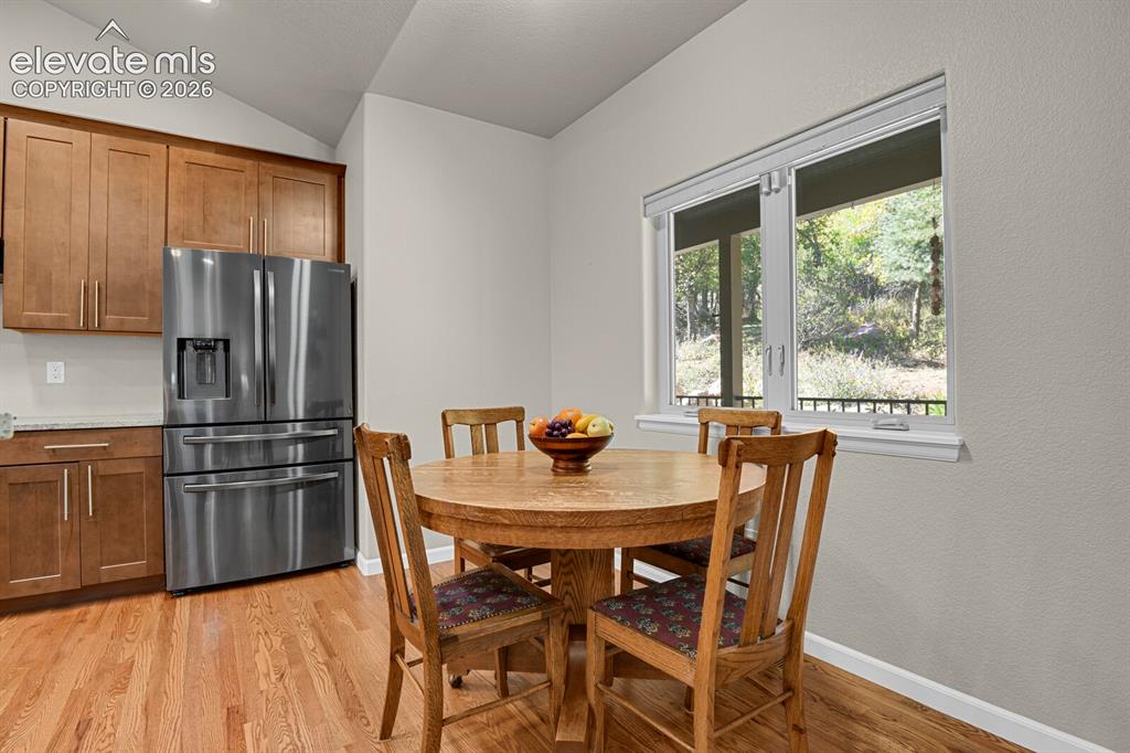 Image 10 of 46: Kitchen featuring natural wood-finish cabinetry, stainless steel french-doo