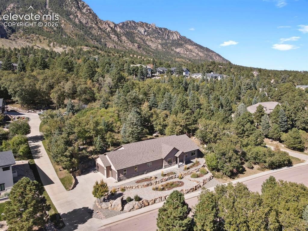 Image 41 of 46: Aerial view of a multi-gabled residence featuring a concrete driveway, tier