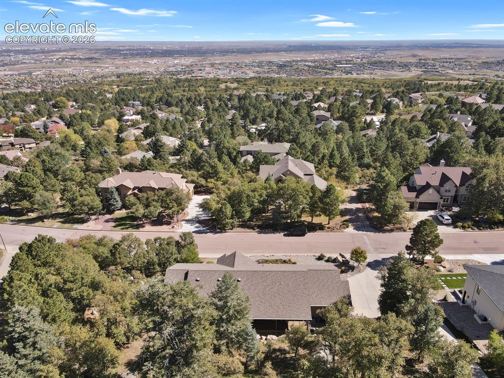 Image 44 of 46: Aerial perspective of a multi-level residence featuring a multi-pitched roo
