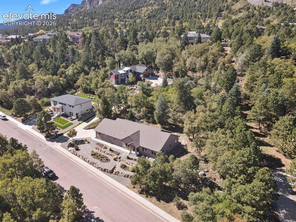 Image 46 of 46: Single-story residence featuring a shingled roof, stone-accented front land