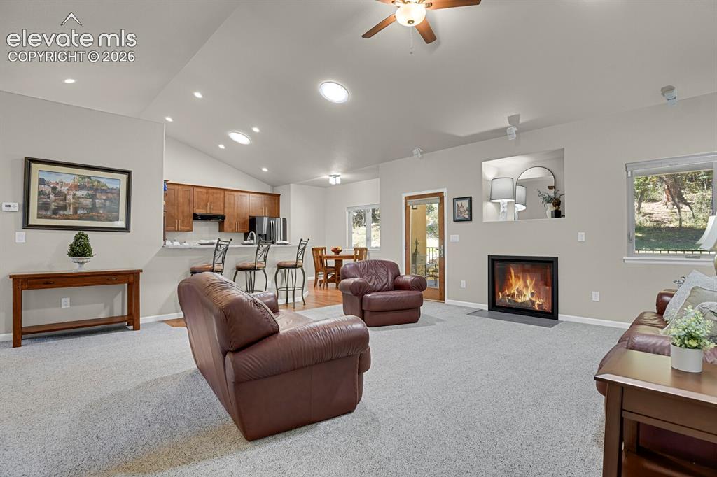 Image 7 of 46: Vaulted ceilings, recessed lighting, fireplace with a clean-lined surround,