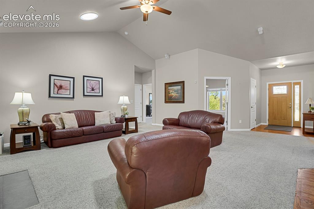 Image 9 of 46: Vaulted ceilings featuring a central light fixture with an integrated ceili