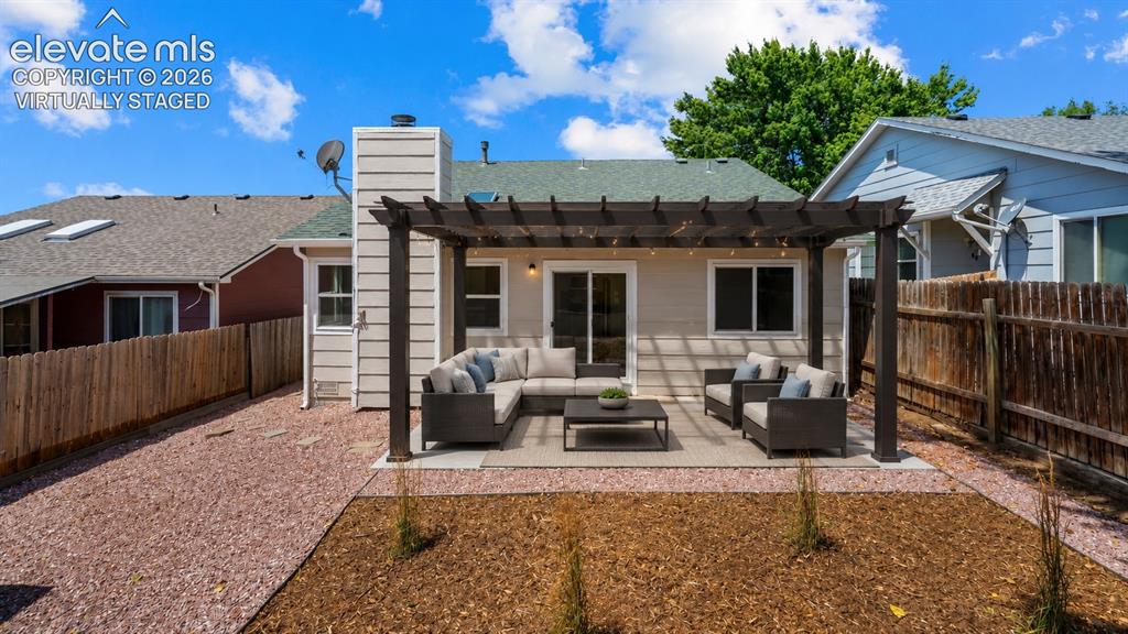Image 30 of 42: Virtually Staged: Patio furniture and pergola have been digitally added to 