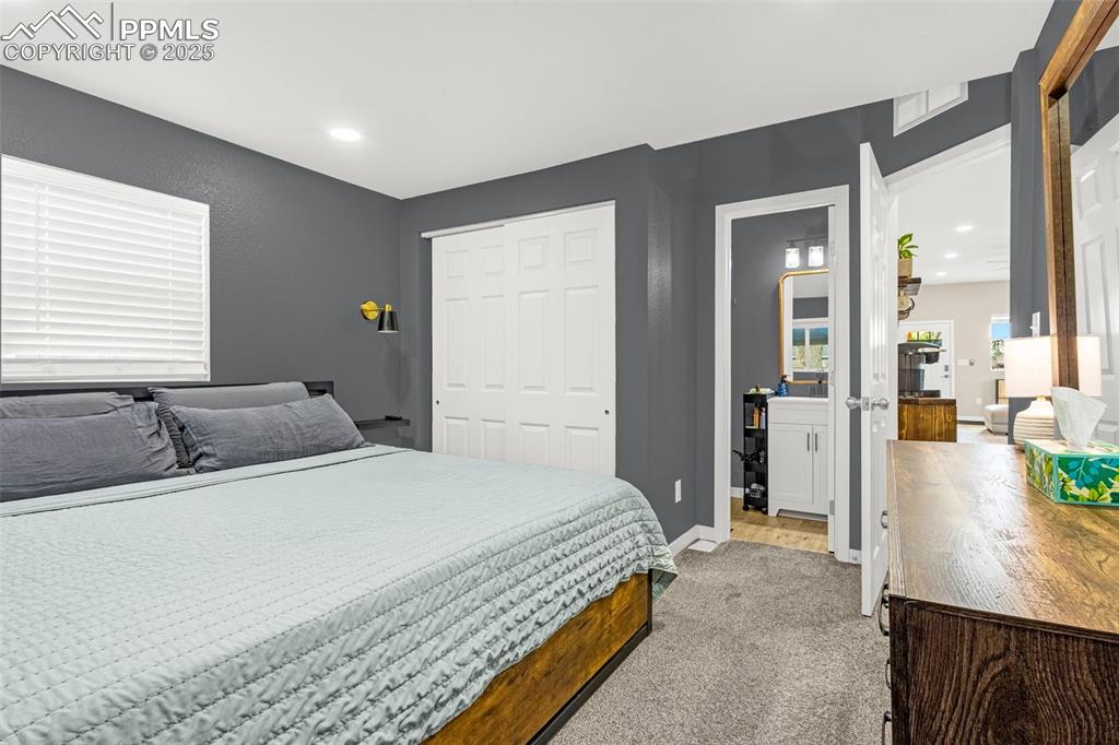 Image 14 of 36: Bedroom featuring light carpet, baseboards, and a closet