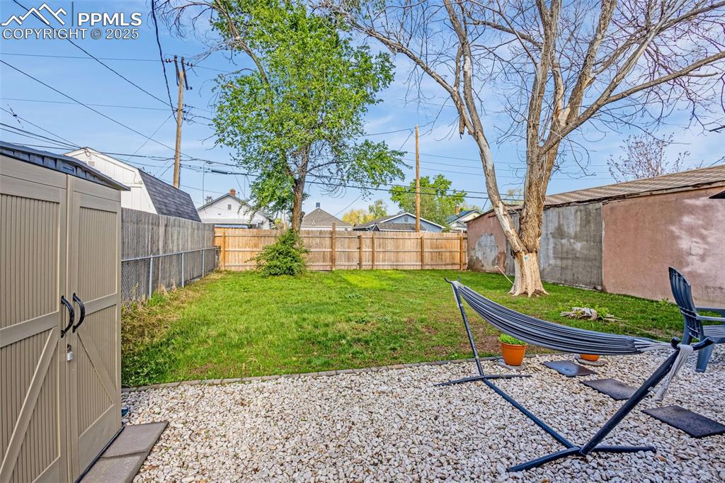 Image 30 of 36: View of yard with a patio, a shed, and an outbuilding