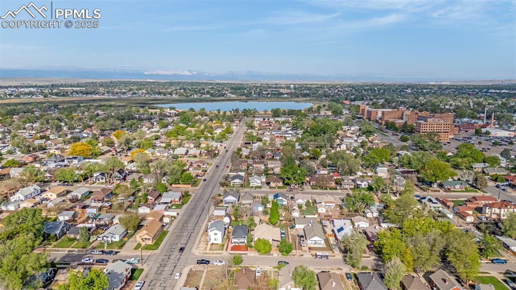 Image 36 of 36: Aerial view of property and surrounding area featuring a large body of wate