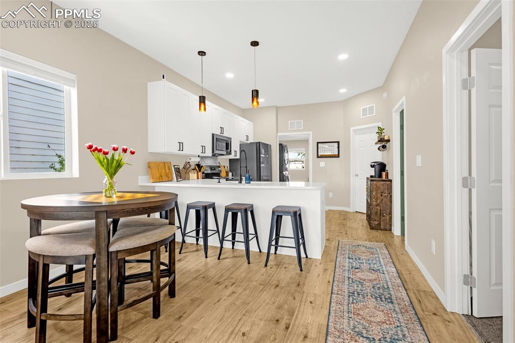 Image 8 of 36: Kitchen featuring appliances with stainless steel finishes, light wood fini