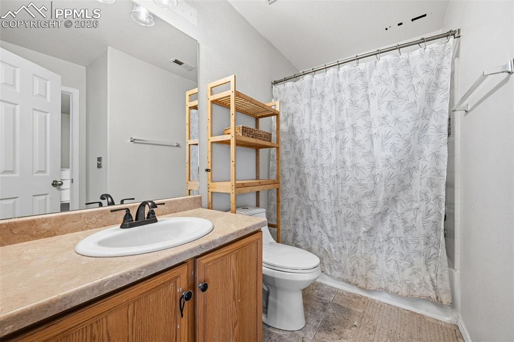 Image 19 of 30: Bathroom featuring vanity and shower / bathtub combination with curtain