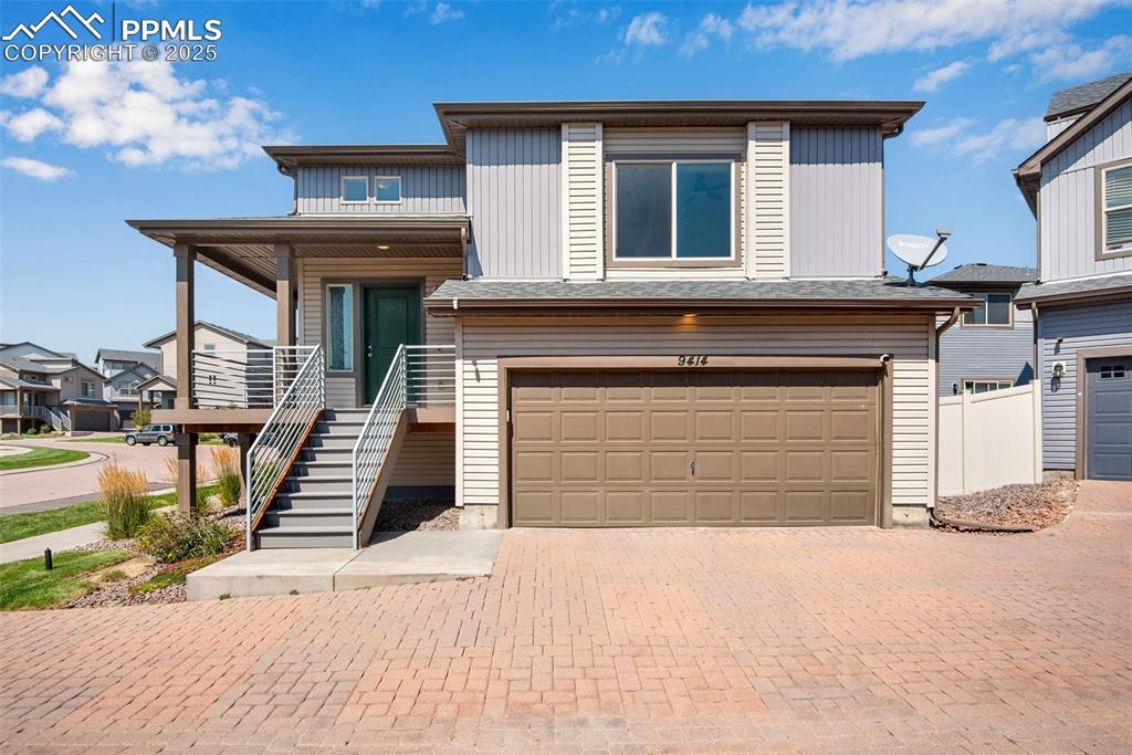 Image 2 of 39: View of front of home featuring an attached garage, decorative driveway, a