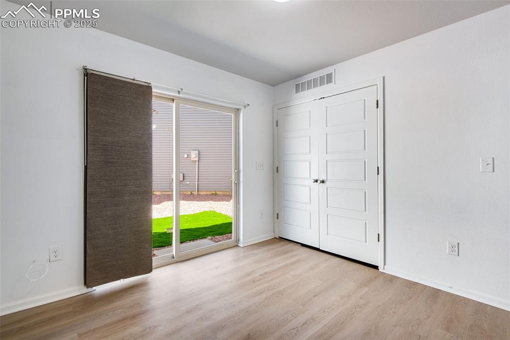 Image 24 of 39: Unfurnished Bonus room with a sliding door, and side/back yard access, with