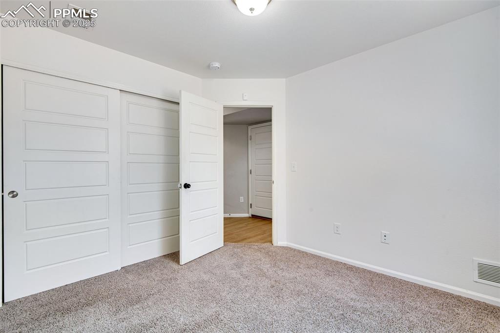 Image 26 of 39: Unfurnished bedroom featuring carpet and a closet