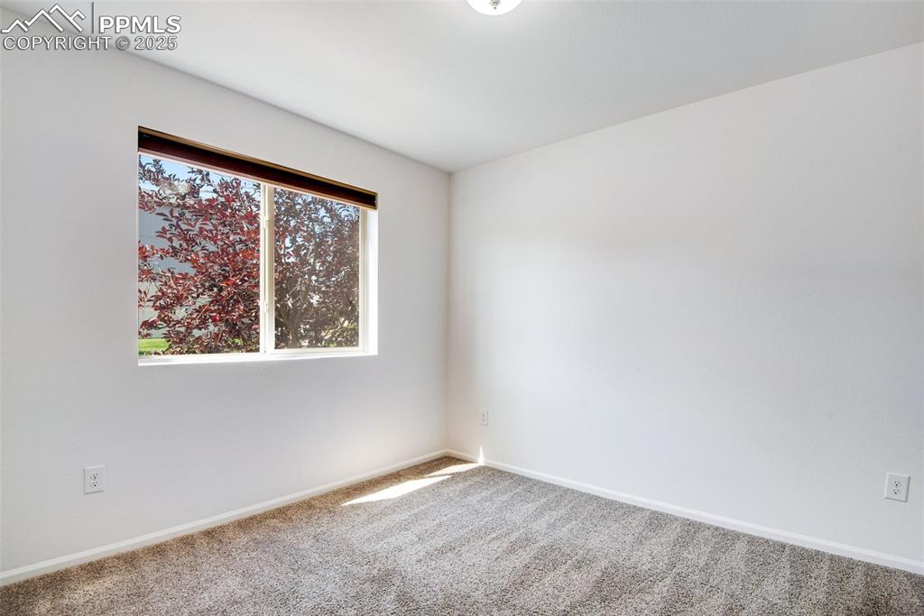 Image 27 of 39: Unfurnished bedroom with carpet flooring and baseboards