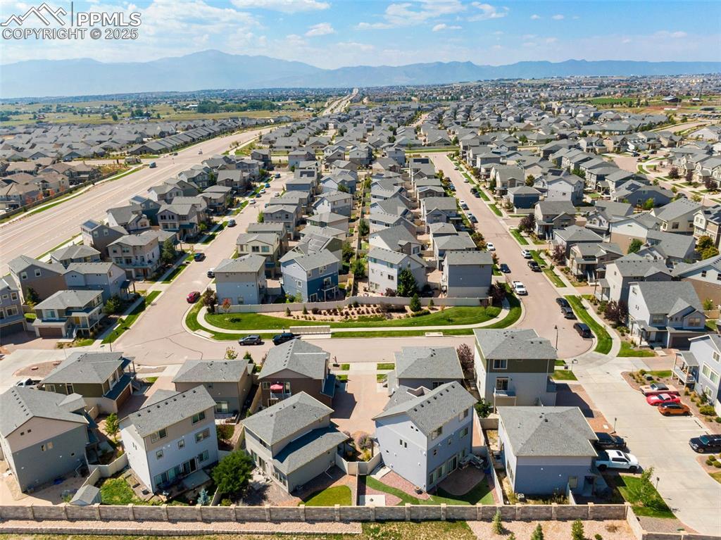 Image 38 of 39: Aerial view of residential area featuring mountains