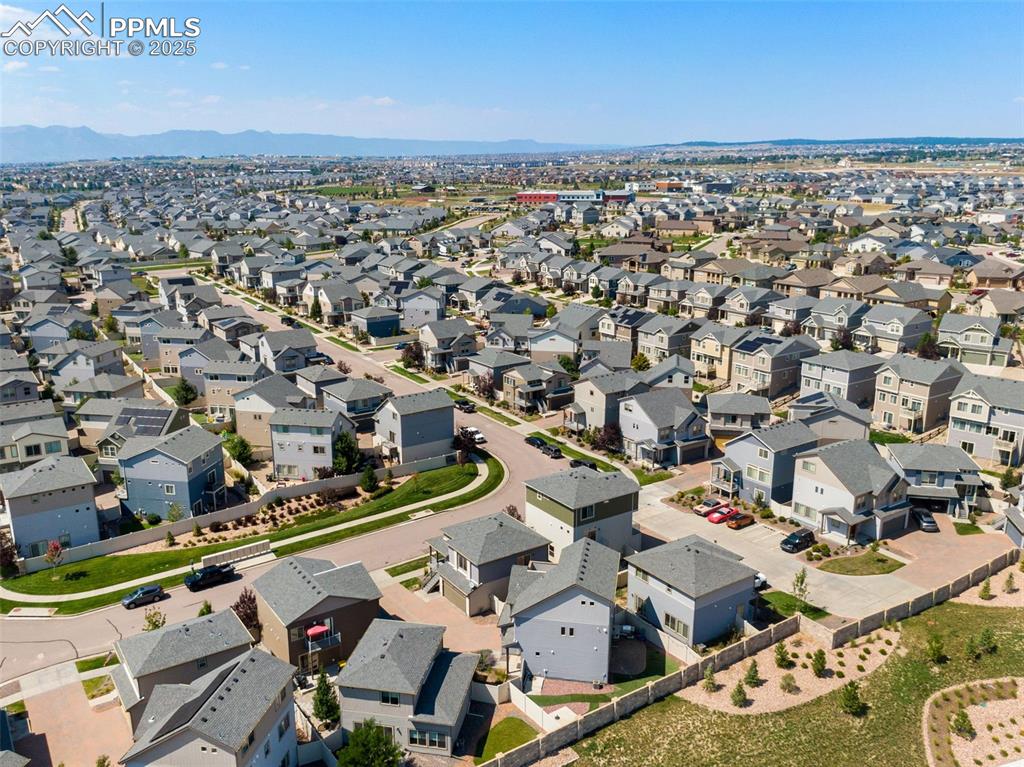 Image 39 of 39: Aerial view of residential area with a mountainous background