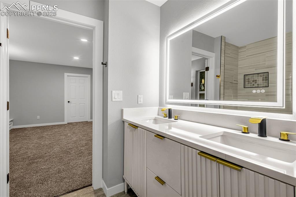 Image 11 of 37: Bathroom featuring double vanity and baseboards
