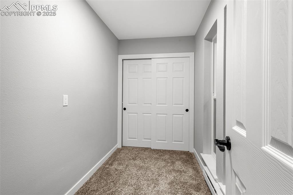 Image 12 of 37: Corridor with carpet and baseboards