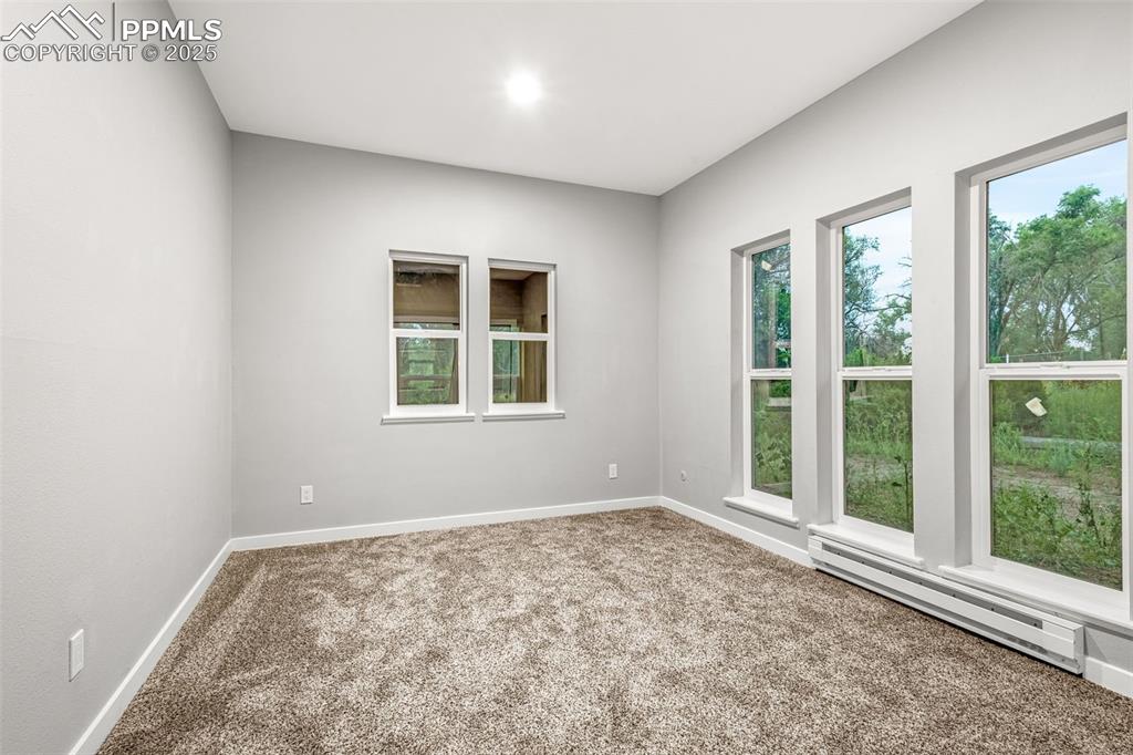 Image 17 of 37: Carpeted empty room featuring a baseboard radiator and baseboards