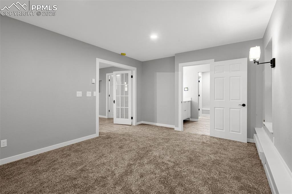 Image 9 of 37: Unfurnished bedroom with carpet floors and ensuite bathroom
