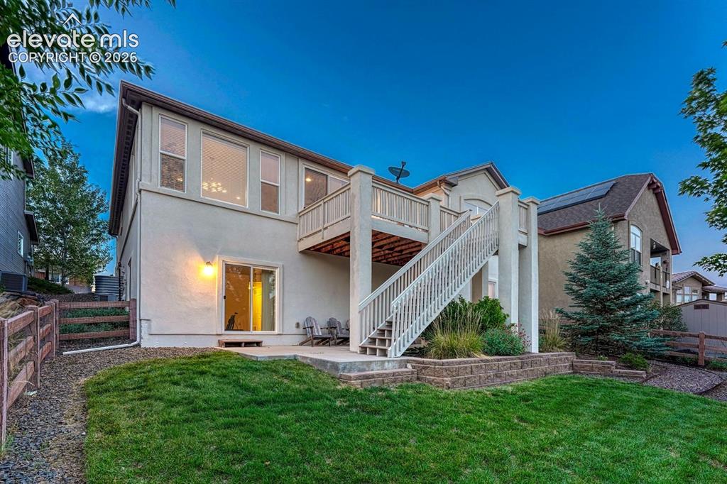 Image 11 of 50: Fenced Backyard with auto sprinklers, partially covered patio, deck, and be