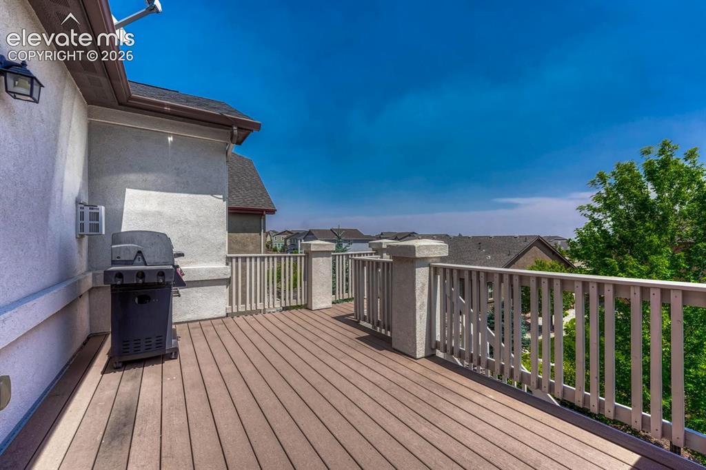Image 17 of 50: Wood deck with stairs to the backyard.