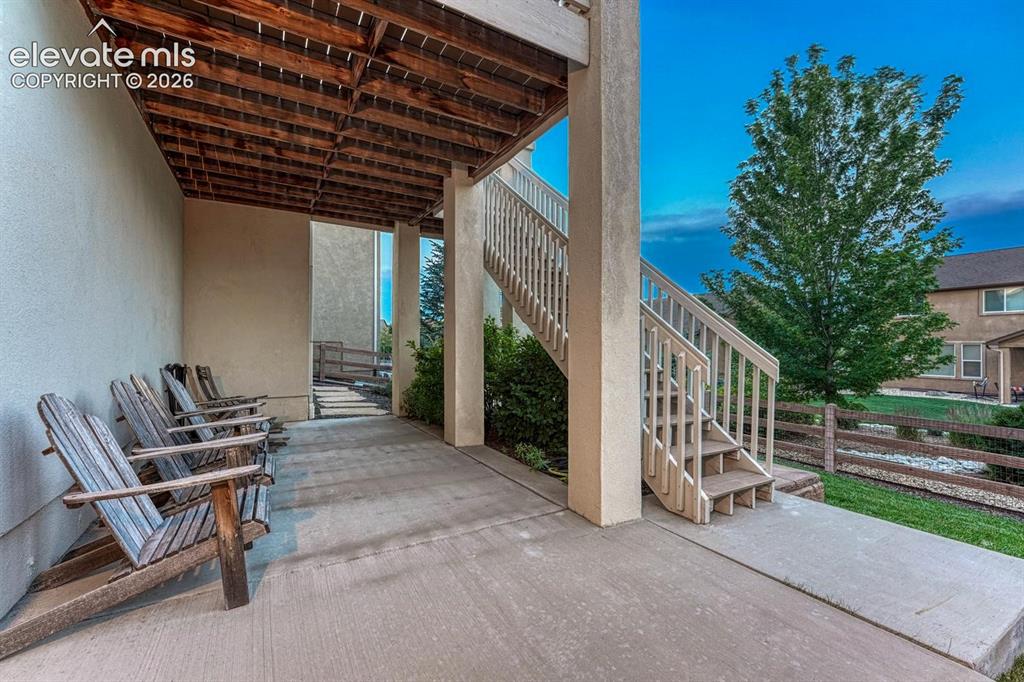 Image 18 of 50: Partial covered back patio located off the basement family/rec room.