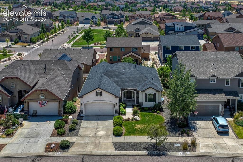 Image 2 of 50: Aerial view of the front of the home and neighborhood.