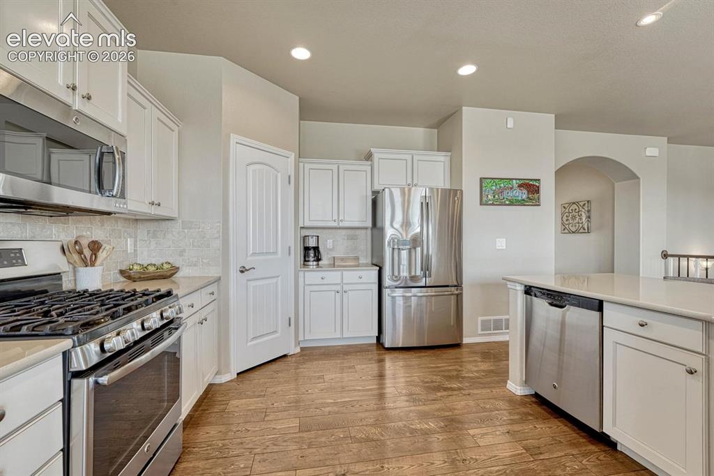 Image 20 of 50: The Kitchen offers a gas range oven, microwave, dishwasher, and French door