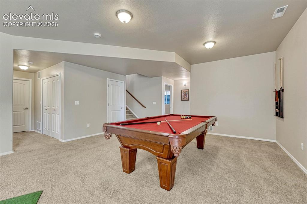 Image 35 of 50: Finished Family/Rec Room with hallway into the Basement Bedrooms.