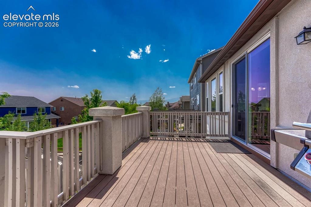 Image 7 of 50: Walk out to a wood deck where you can enjoy mountain views and the fabulous
